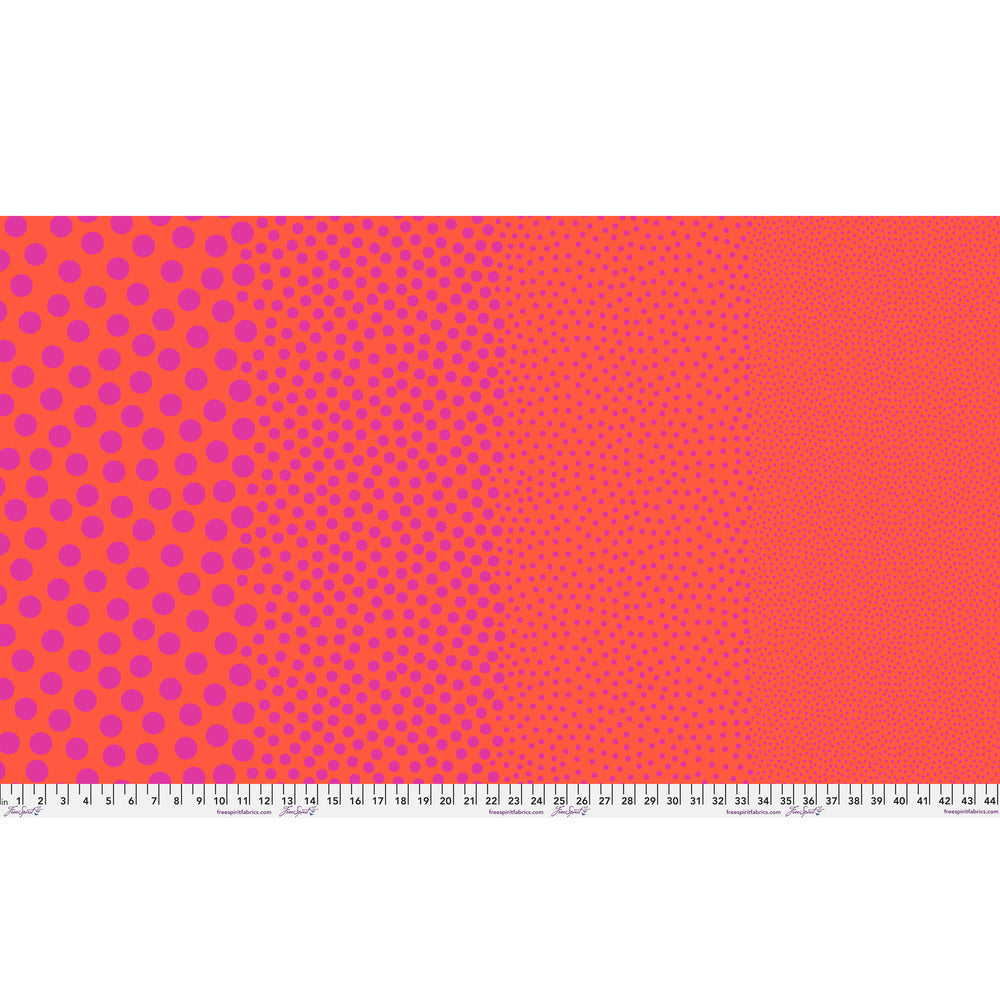 Stones in Tomato by Tula Pink — full-width fabric view showing four dot sizes.