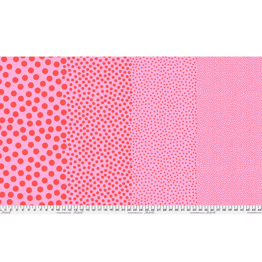 Stones in Watermelon by Tula Pink — full-width fabric view showing four dot sizes.